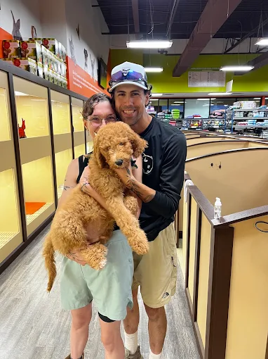 Visitors holding a puppy inside Petland